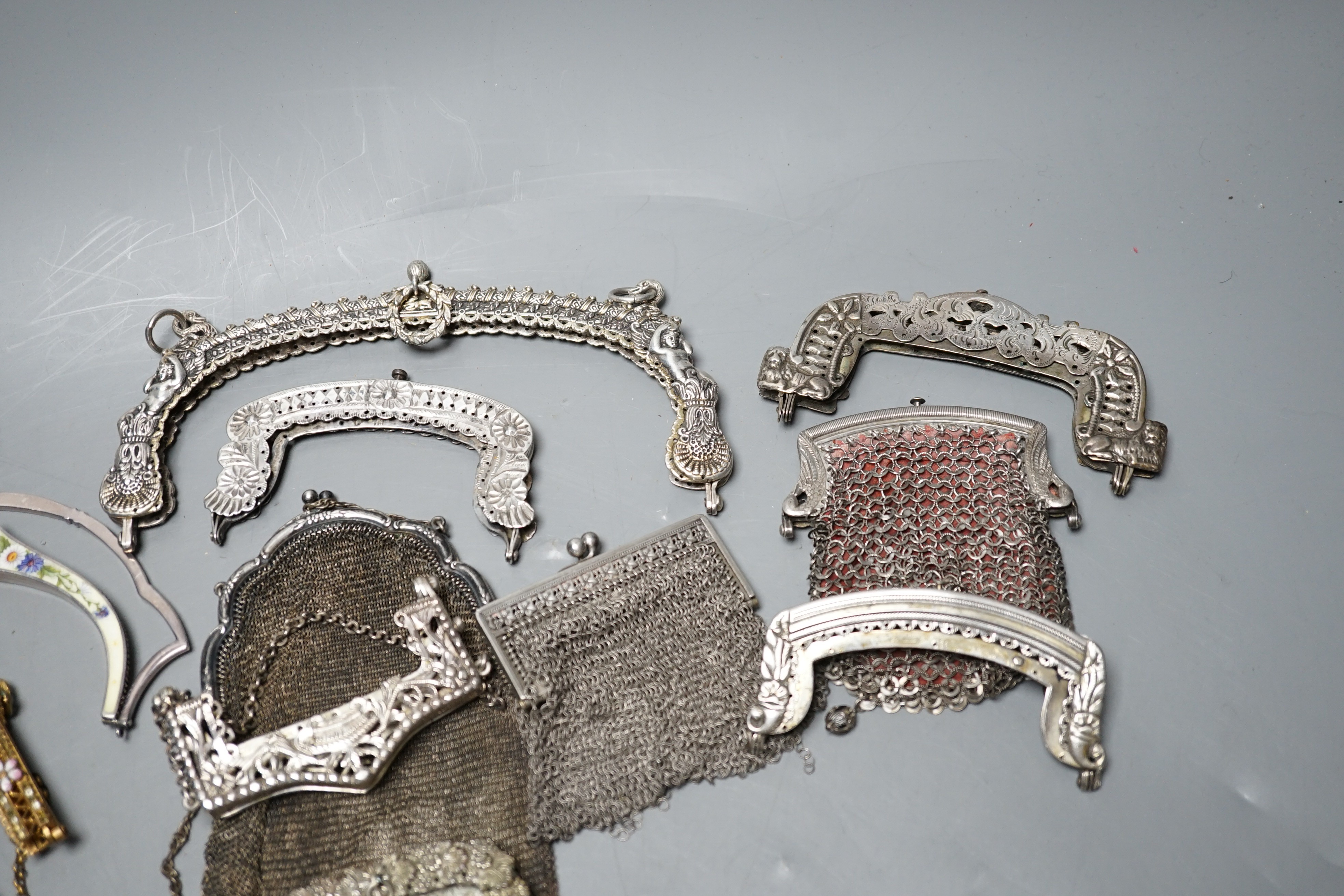 A silver enamel handbag frame, a gilt metal diamanté and enamel frame, eight mixed metal frames, a chain mail bag and three purses, late 19th early 20th century